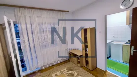 Small living room with furniture and access to the terrace, with a view of the kitchen. - image 3