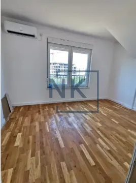 Empty room with hardwood flooring and an air conditioning unit on the wall. - image 4