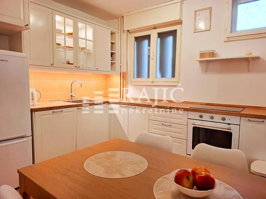 Bright kitchen with a dining table and white cabinets.