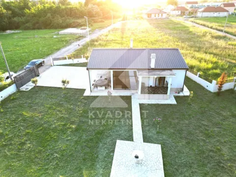 Aerial view of a single-story house with a landscaped yard and lawn. - image 24