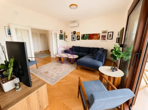 Living room with a sofa, TV, and access to the terrace. - image 4