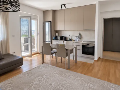 Modern kitchen with dining area and access to the terrace. - image 2
