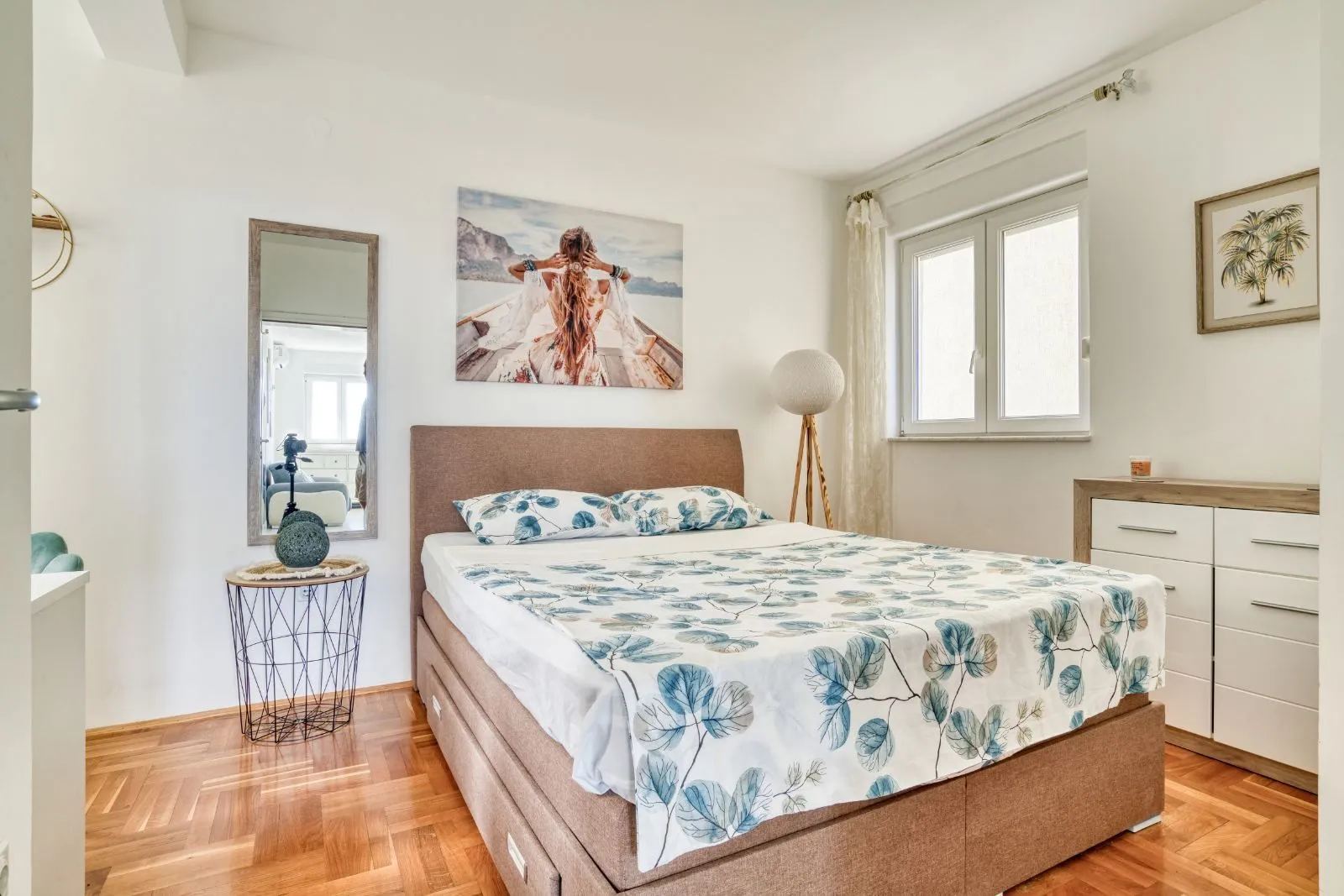 Bedroom with a double bed, chest of drawers, mirror and window.