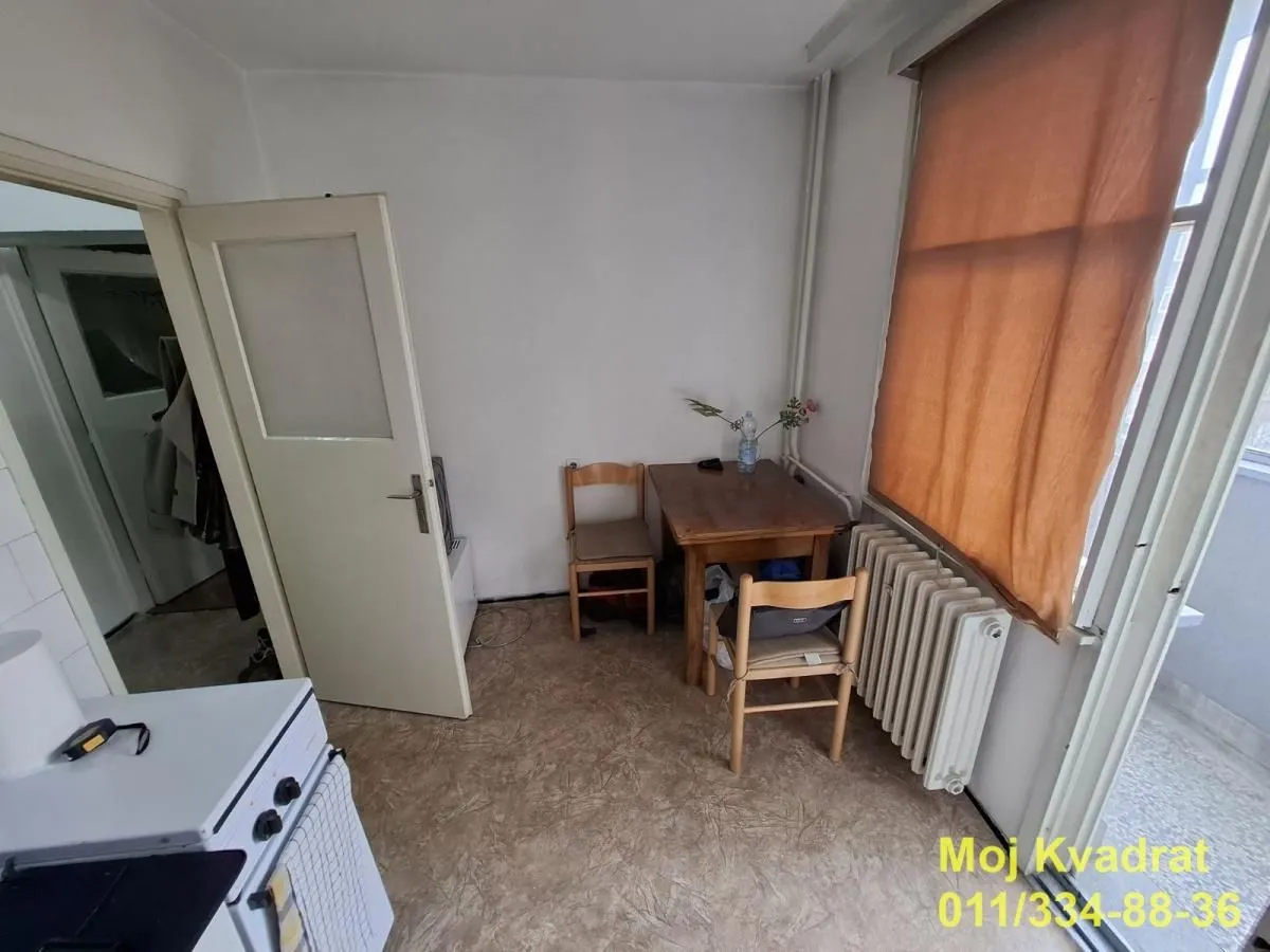 Small kitchen with a dining table and chairs.