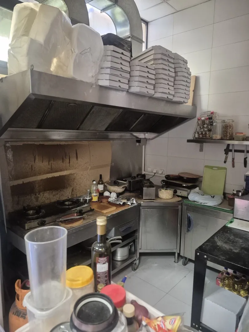 Commercial kitchen with stainless steel elements and catering equipment.
