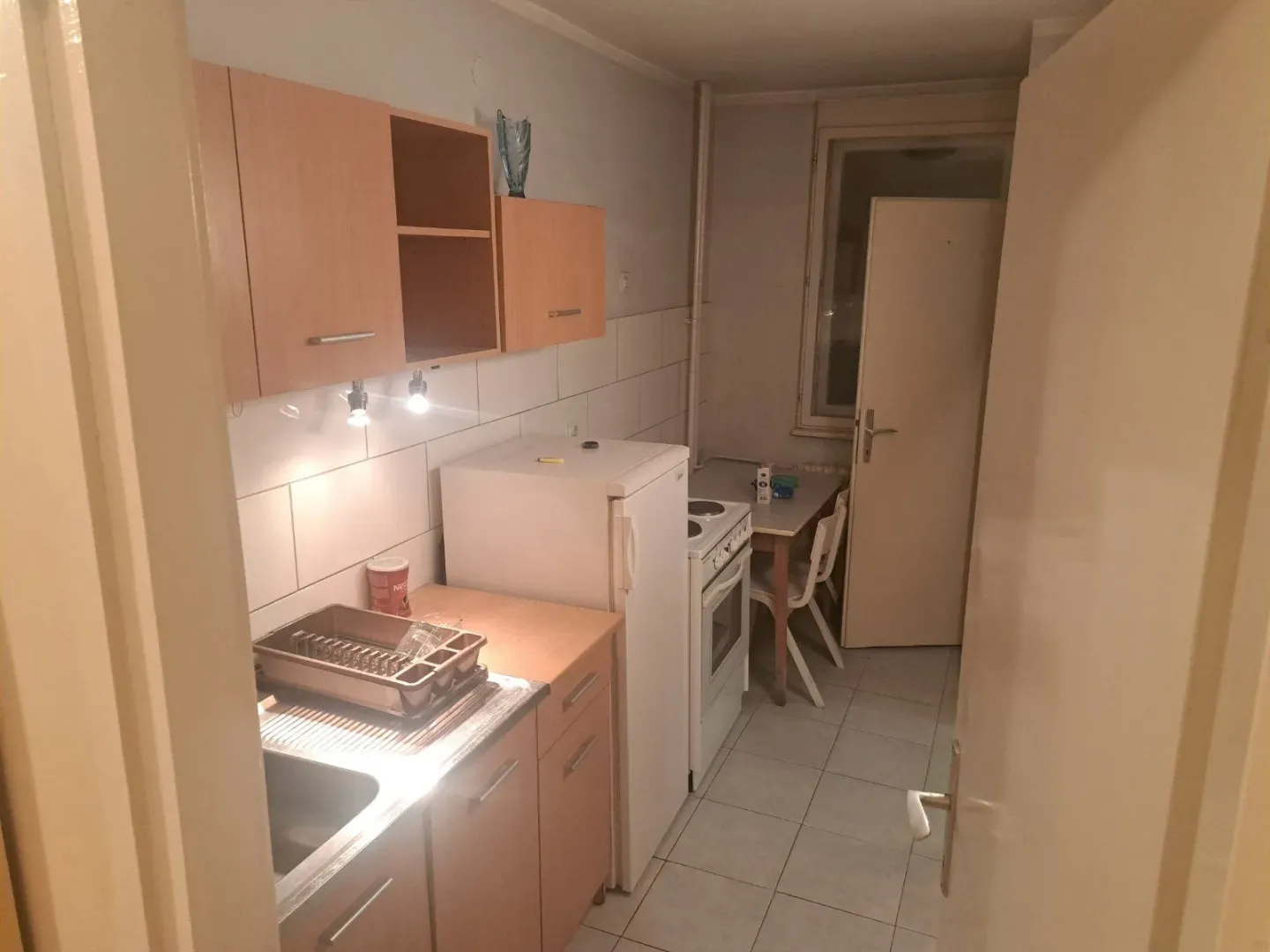 Smaller kitchen with wooden units, a refrigerator, and a stove.
