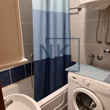 Manje kupatilo sa kadom, plavo-bijelom zavjesom za tuširanje i veš mašinom. - image 9