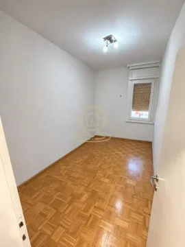 Empty room with parquet flooring and a window. - image 10