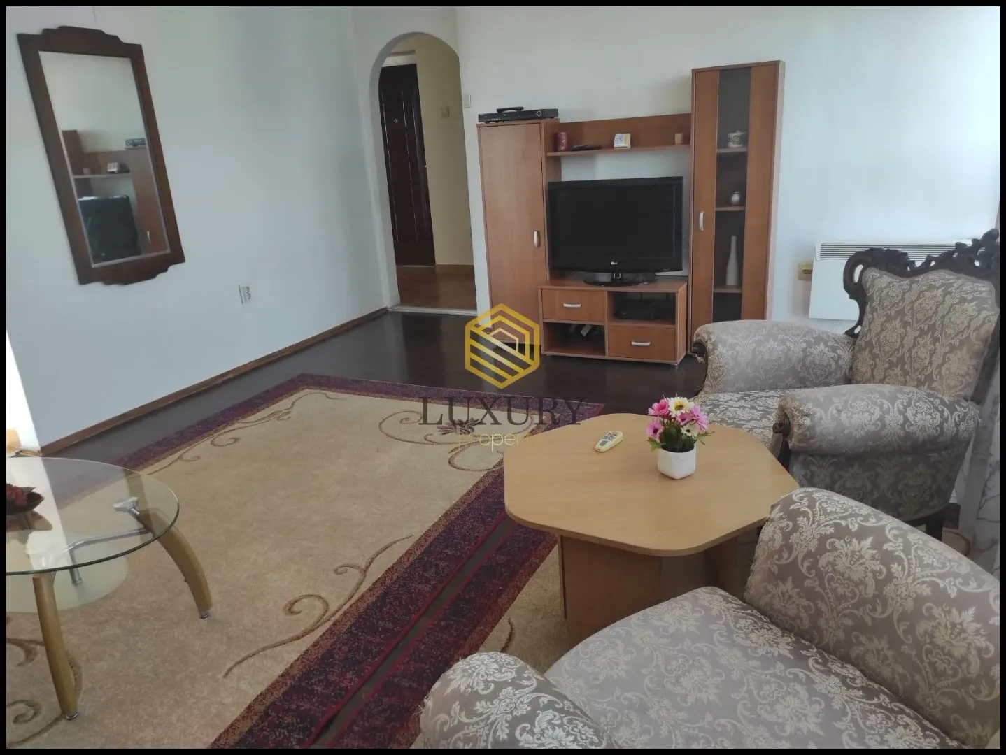 Living room with furniture, television, and coffee table.