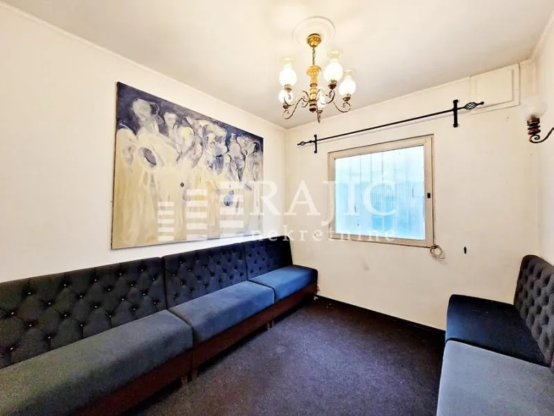 Living room with seating furniture and an art painting on the wall.