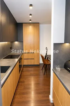 Moderna kuhinja sa drvenim elementima i tamnim radnim površinama. - image 6