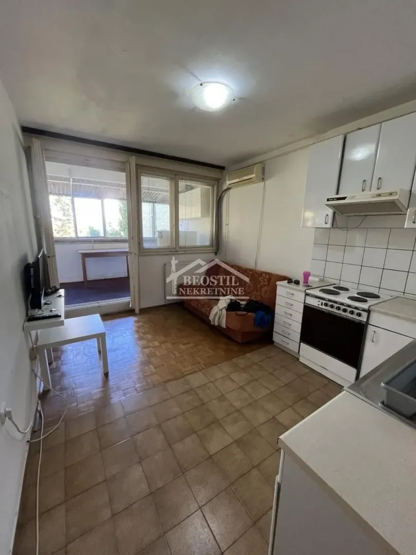 Small kitchen connected to the living area with access to the terrace.