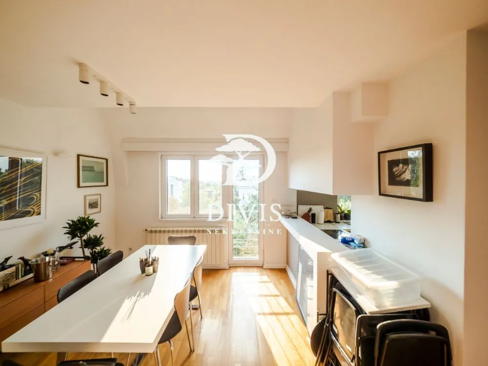 Spacious living room with a dining table and an exterior view.