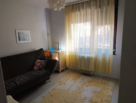 Living room with a sofa and a window covered with yellow curtains. - image 14