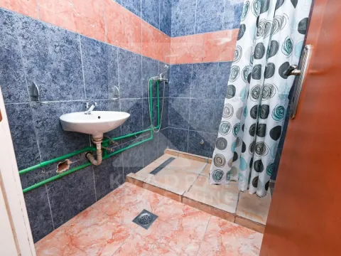 Bathroom with a sink and a shower cabin with a curtain. - image 4