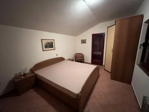 Bedroom featuring a double bed, a wardrobe, and nightstands. - image 23