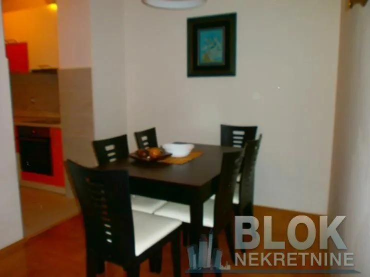 Dining area with a table and chairs, overlooking the kitchen.