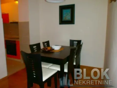 Dining area with a table and chairs, overlooking the kitchen. - image 11