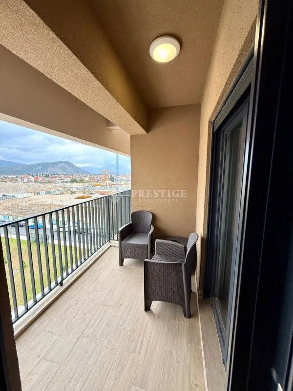 Furnished balcony with seating set and view of the surroundings.