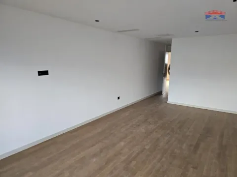 Empty room with white walls and hardwood flooring. - image 6