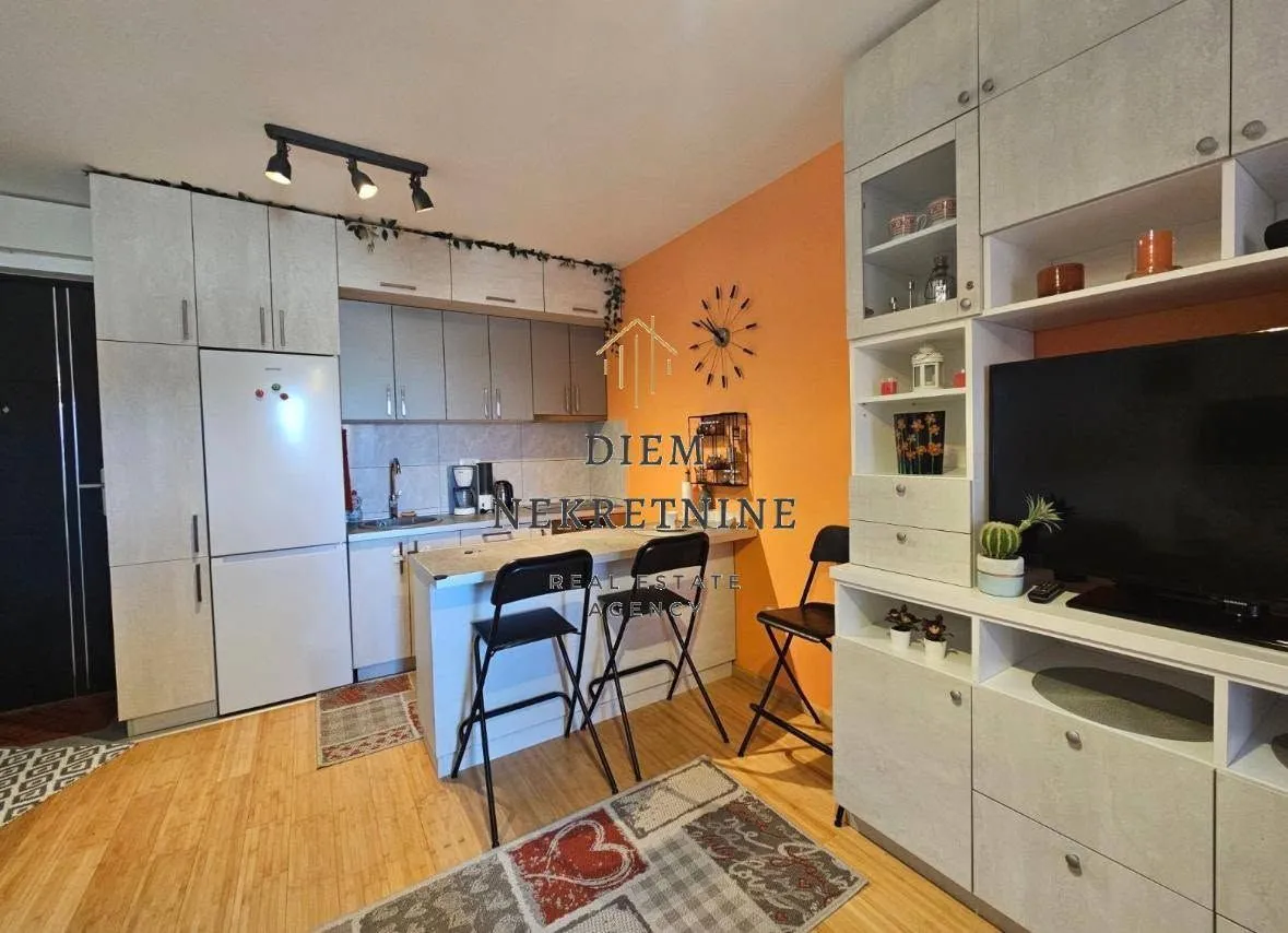 Smaller kitchen with a breakfast bar and dining area integrated into the living space.