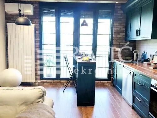 Modern kitchen with a breakfast bar and dark cabinetry.