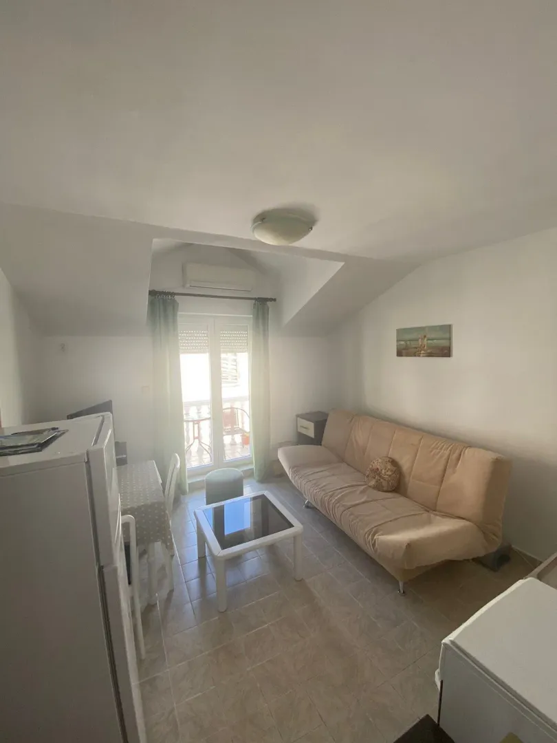 Living room with a sofa, coffee table, and access to the terrace.