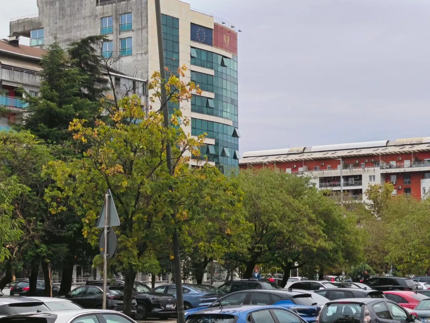 View of the building and surrounding area with parked cars in the foreground.