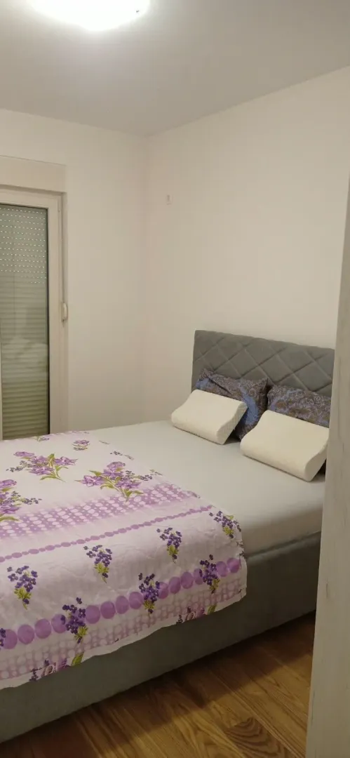 Tidy bedroom with a double bed and a window.
