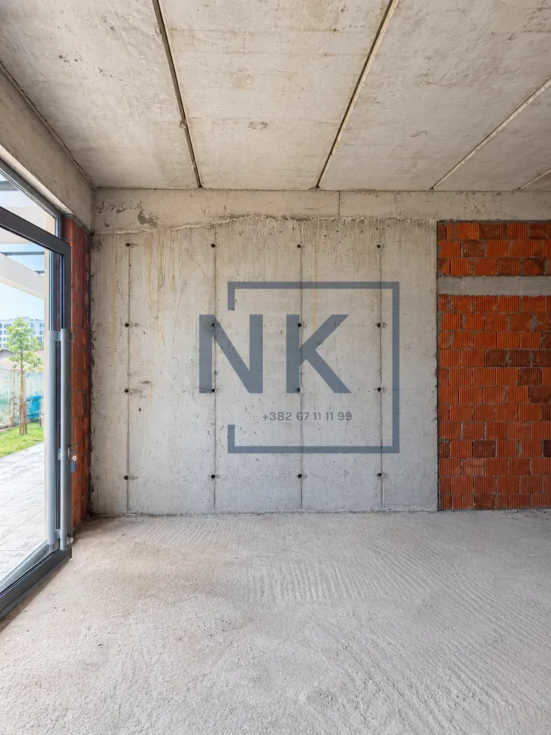 View of an unfurnished space in rough construction phase with terrace access.