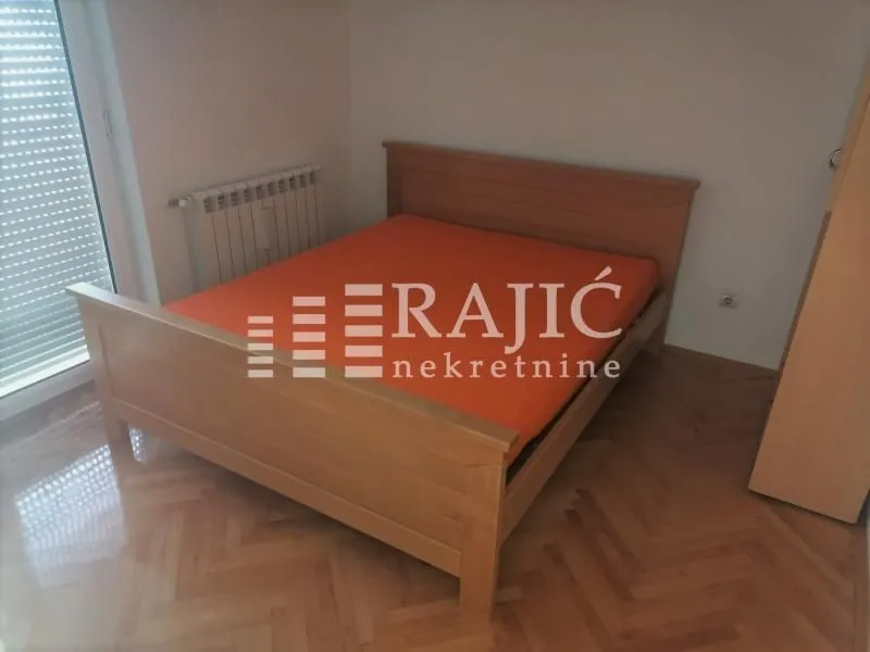 Bedroom with a double bed and parquet flooring.