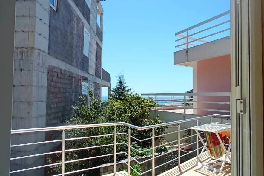 View from the terrace towards surrounding buildings and the sea.