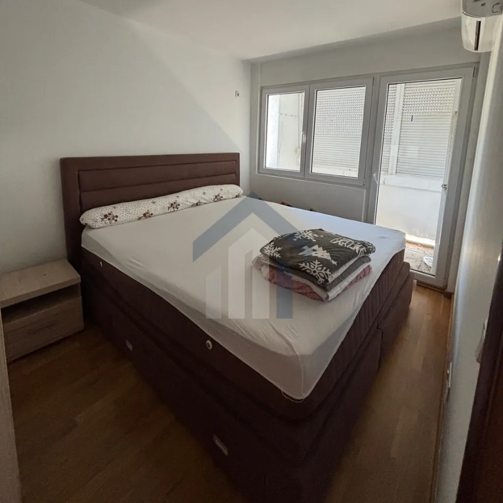 Bedroom with a double bed and balcony access.
