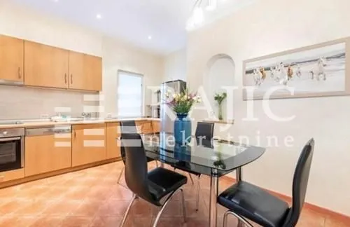 Spacious kitchen with a dining area and wooden cabinetry.