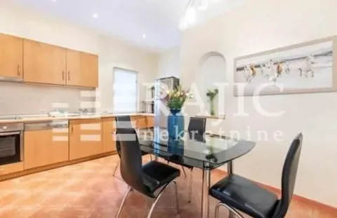 Spacious kitchen with a dining area and wooden cabinetry. - image 6