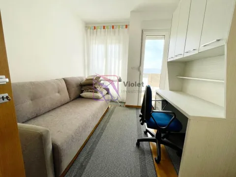 Small bedroom with a sofa bed and a desk. - image 5