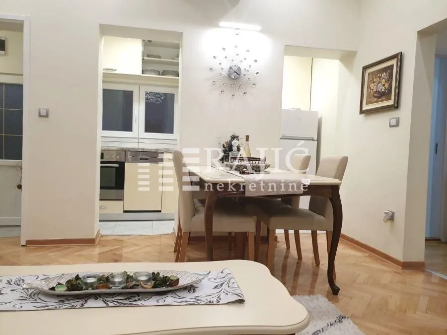 Living room with dining area and view of the kitchen.