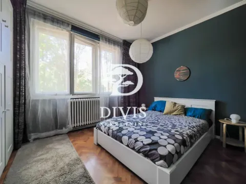 Bedroom with a double bed, dark accent wall, and a large window. - image 12