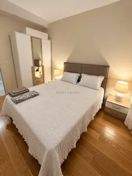 Furnished bedroom with a double bed, wardrobe, and nightstands. - image 6