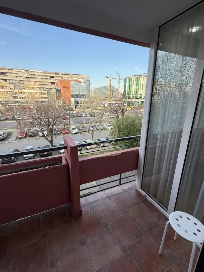 Natkriveni balkon sa pločicama i pogledom na grad.