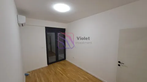 Empty room with hardwood flooring and balcony doors. - image 6