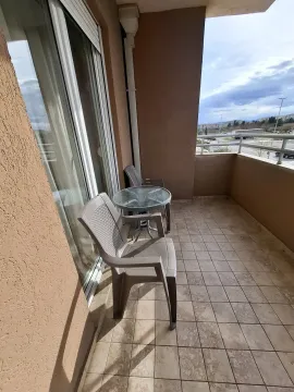 Spacious balcony with outdoor seating and a view of the surroundings. - image 11