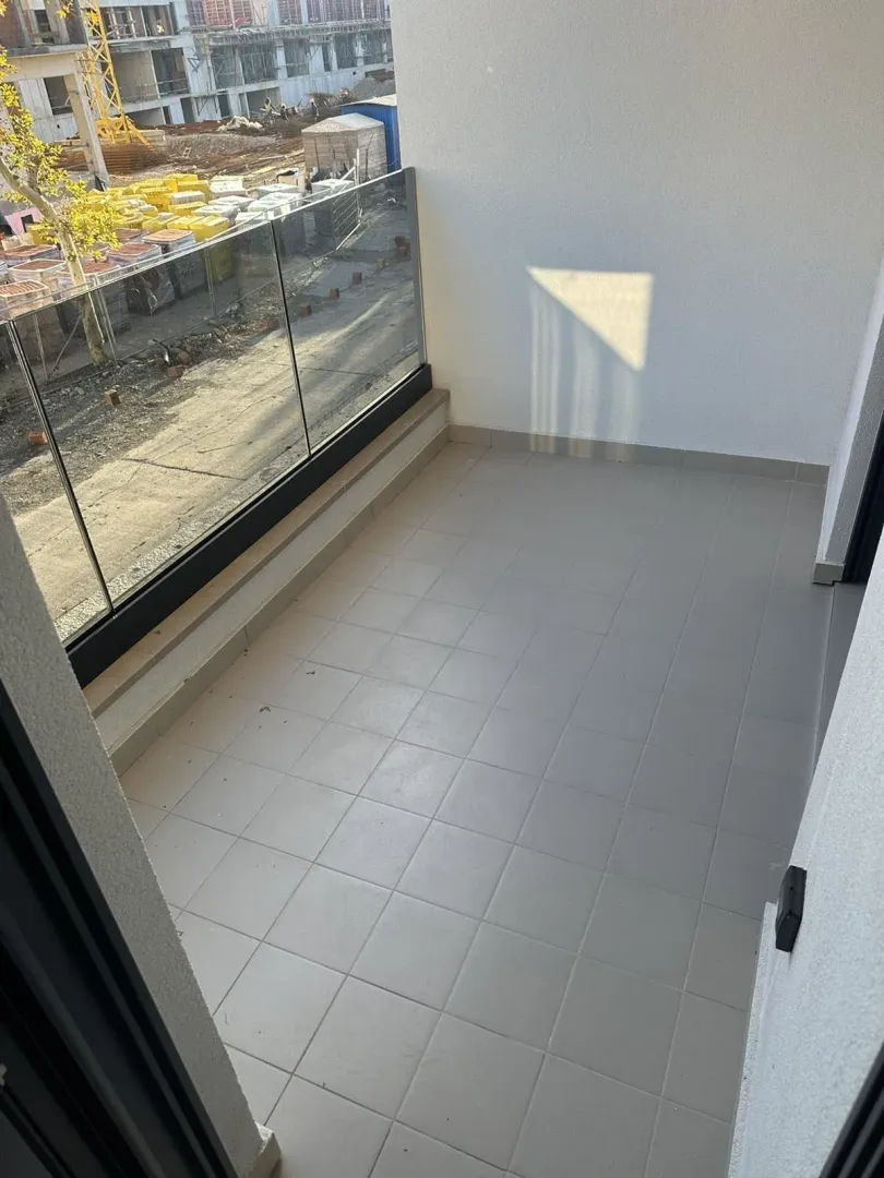 Empty balcony with a glass railing.