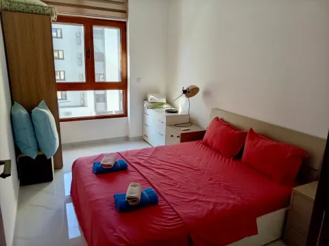 Bright bedroom with a double bed, wardrobe, and a window. - image 4