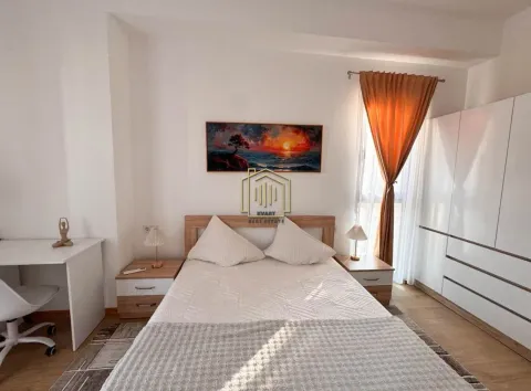 Furnished bedroom with a double bed, desk, and wardrobe. - image 4