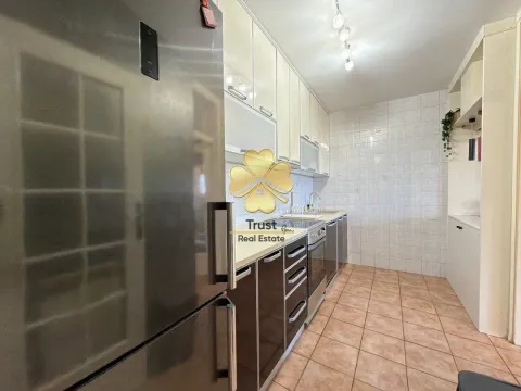 Modern kitchen with dark and light cabinets and a large refrigerator. - image 6