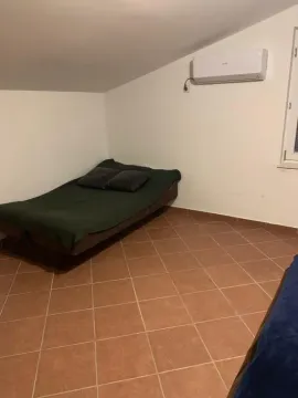 Smaller bedroom with a bed and an air conditioner. - image 11