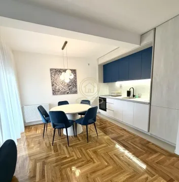 Modern kitchen with a dining area and parquet flooring. - image 3