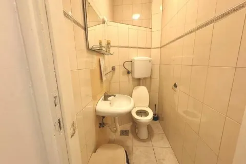 Smaller tiled bathroom with a toilet and a washbasin. - image 10