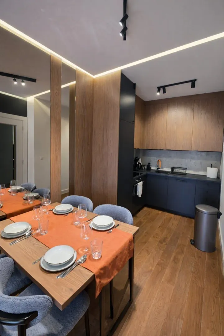 Modern kitchen with a dining table and built-in appliances.